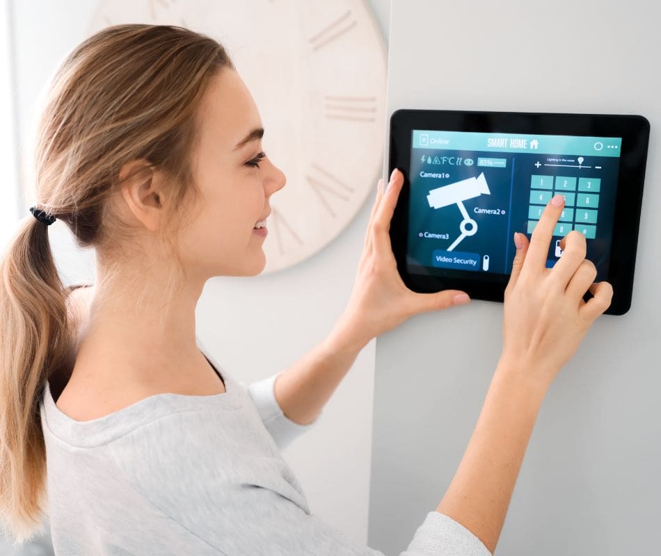 Woman setting up video security for her house using smart home technology