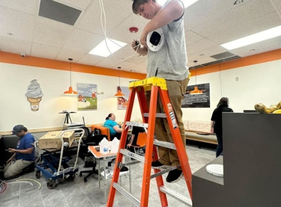 SoDak Technologies worker installing audio system at commercial property